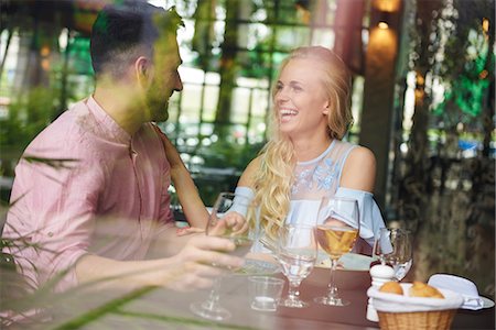 simsearch:649-08824511,k - Window view of young woman with boyfriend laughing at restaurant table Stock Photo - Premium Royalty-Free, Code: 649-08969400