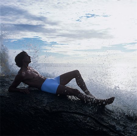 simsearch:614-08880777,k - Man lying on rock in sea looking away, China Bay, Sri Lanka, Asia Stock Photo - Premium Royalty-Free, Code: 649-08969472