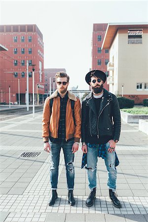simsearch:649-08969957,k - Portrait of two young male hipster friends standing in city housing estate, full length Photographie de stock - Premium Libres de Droits, Code: 649-08969929