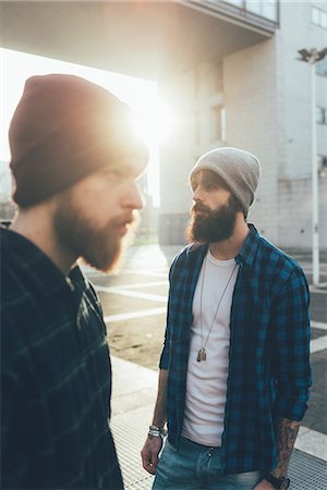 Portrait of two young male hipsters in knit hats in city sunlight Stock Photo - Premium Royalty-Free, Code: 649-08969958