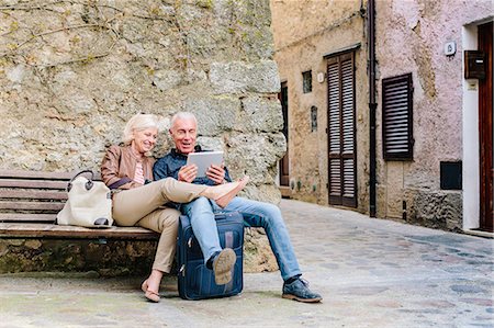 senior man relaxing - Tourist couple sitting on bench looking at digital tablet in Siena, Tuscany, Italy Stock Photo - Premium Royalty-Free, Code: 649-08987834