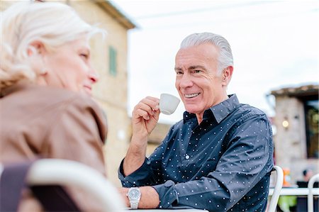 square - Over shoulder view of tourist couple drinking espresso at sidewalk cafe, Siena, Tuscany, Italy Stock Photo - Premium Royalty-Free, Code: 649-08987839