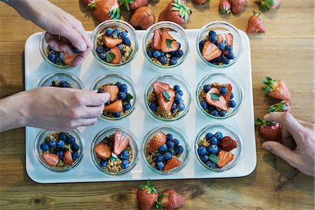 photos of blueberries for kitchen - Two chefs preparing berry desserts, overhead view Stock Photo - Premium Royalty-Free, Code: 649-08987878