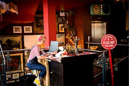 simsearch:649-08987947,k - Quirky woman working at high counter at bar and restaurant, Bournemouth, England Stock Photo - Premium Royalty-Free, Code: 649-08987957