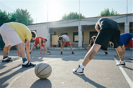 simsearch:649-07520889,k - Friends on basketball court warming up Fotografie stock - Premium Royalty-Free, Codice: 649-08988140