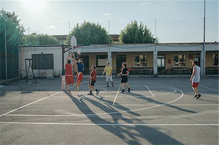 Friends on basketball court playing basketball game Stock Photo - Premium Royalty-Free, Code: 649-08988161