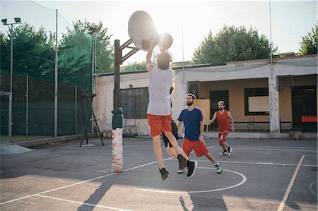 Friends on basketball court playing basketball game Stock Photo - Premium Royalty-Free, Code: 649-08988163