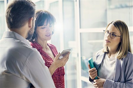 simsearch:614-08031039,k - Businessman and businesswomen having meeting in office Stock Photo - Premium Royalty-Free, Code: 649-08988246