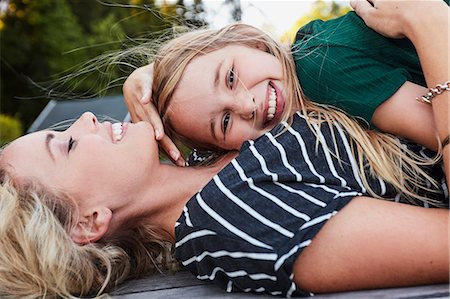 simsearch:649-08118903,k - Mother and daughter lying on wooden decking outdoors Stock Photo - Premium Royalty-Free, Code: 649-08988365