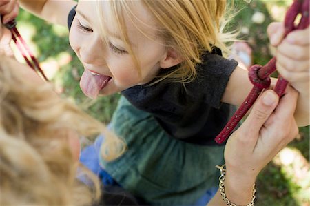 swing mother daughter - Girl sticking tongue out Stock Photo - Premium Royalty-Free, Code: 649-08988361