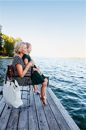 simsearch:649-08118903,k - Mother and daughter sitting on pier by water Stock Photo - Premium Royalty-Free, Code: 649-08988408
