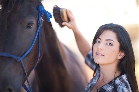 Young woman grooming horse Stock Photo - Premium Royalty-Free, Code: 649-09004163