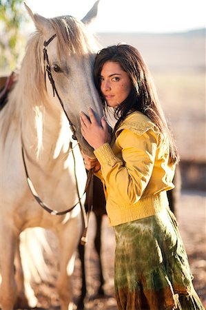 simsearch:649-09003874,k - Young woman touching horse's face Foto de stock - Royalty Free Premium, Número: 649-09004175