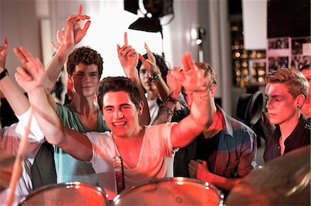 people dancing in night club with arms in air - Teenage boys at rock concert Stock Photo - Premium Royalty-Free, Code: 649-09004371