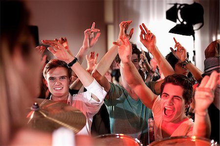 people dancing in night club with arms in air - Teenage boys at rock concert Stock Photo - Premium Royalty-Free, Code: 649-09004372