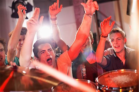 people dancing in night club with arms in air - Teenage boys at rock concert Stock Photo - Premium Royalty-Free, Code: 649-09004373