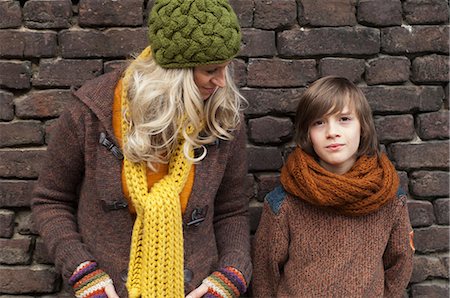 Mother and son standing against brick wall, portrait Stock Photo - Premium Royalty-Free, Code: 649-09004490