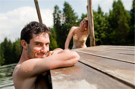 simsearch:649-09002373,k - Couple swimming in a lake with a pier Stock Photo - Premium Royalty-Free, Code: 649-09002374