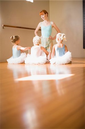 picture of woman kneeling down from behind - Ballet teacher talking to students Stock Photo - Premium Royalty-Free, Code: 649-09002561