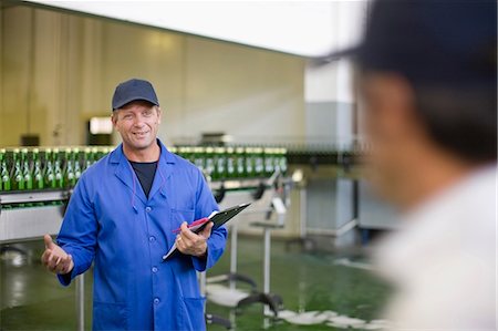 Worker with clipboard in factory Stock Photo - Premium Royalty-Free, Code: 649-09002644