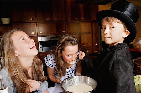 Girl tasting boy magician?s cooking Stock Photo - Premium Royalty-Free, Code: 649-09002694