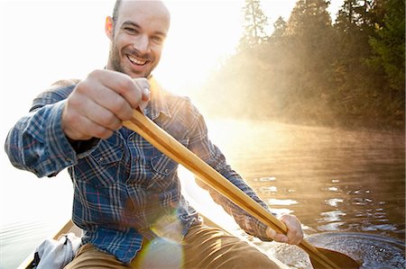 simsearch:614-06720064,k - Man rowing canoe in still lake Stock Photo - Premium Royalty-Free, Code: 649-09002958