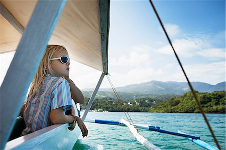 Girl relaxing in boat on still lake Stock Photo - Premium Royalty-Free, Code: 649-09003038
