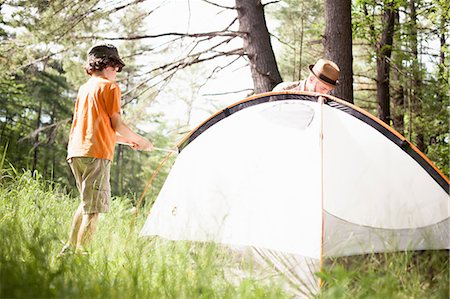 father son camping woods - Father and son pitching tent in forest Stock Photo - Premium Royalty-Free, Code: 649-09003674