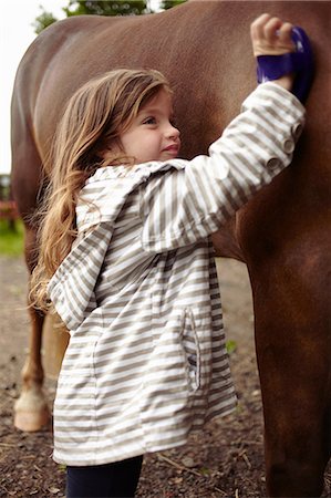 simsearch:649-09003830,k - Girl brushing horse's coat outdoors Stock Photo - Premium Royalty-Free, Code: 649-09003828