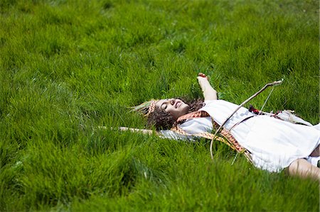 Girl in Native American costume in grass Stock Photo - Premium Royalty-Free, Code: 649-09003877