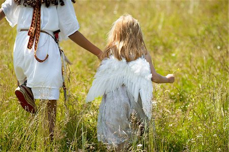 preteen angel - Girls in costumes walking in field Stock Photo - Premium Royalty-Free, Code: 649-09003879