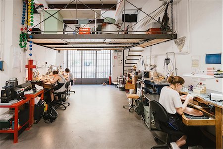 simsearch:649-09269171,k - Three female jewellers working at jewellery workshop workbenches Stock Photo - Premium Royalty-Free, Code: 649-09016533