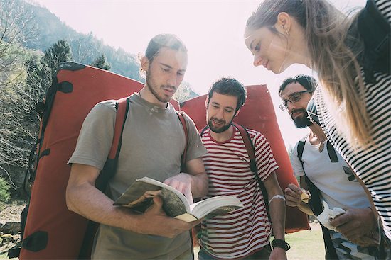 Adult bouldering friends looking at guide book, Lombardy, Italy Stock Photo - Premium Royalty-Free, Image code: 649-09016742