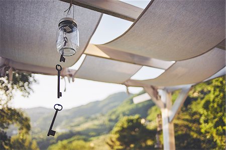 symbolic picture - Key wind chime hanging from patio rafter, Lucca, Tuscany, Italy Stock Photo - Premium Royalty-Free, Code: 649-09016834