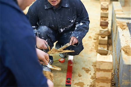 stirring a train - Student learning how to do building work Stock Photo - Premium Royalty-Free, Code: 649-09017042