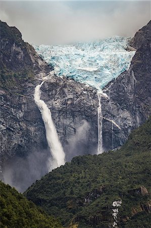 scenic and waterfall chile - Waterfall flowing from glazier at edge of mountain rock face, Queulat National Park, Chile Stock Photo - Premium Royalty-Free, Code: 649-09017179