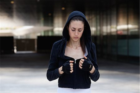 fingerless gloves - Young woman outdoors, wearing hooded top and fingerless gloves Stock Photo - Premium Royalty-Free, Code: 649-09025389