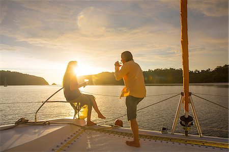 simsearch:649-09166665,k - Couple relaxing on yacht at sunset, Koh Rok Noi, Thailand, Asia Stock Photo - Premium Royalty-Free, Code: 649-09025473