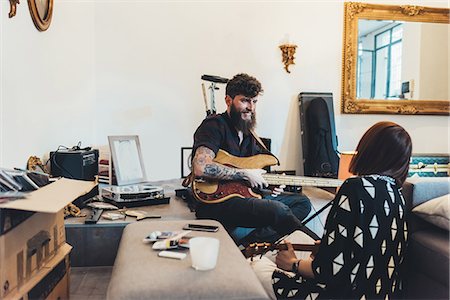 flat sharing - Couple playing electric guitars in apartment Stock Photo - Premium Royalty-Free, Code: 649-09025533
