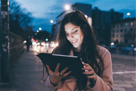 simsearch:649-09025622,k - Young woman, outdoors, at night, looking at digital tablet, face illuminated Stock Photo - Premium Royalty-Free, Code: 649-09025606