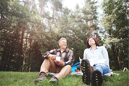 simsearch:649-08381585,k - Mature couple relaxing on grass beside tent Stock Photo - Premium Royalty-Free, Code: 649-09025681