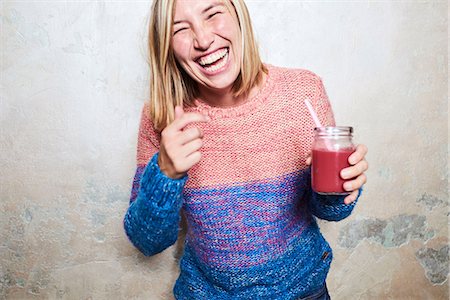 solo woman - Portrait of woman holding smoothie, laughing Stock Photo - Premium Royalty-Free, Code: 649-09025832