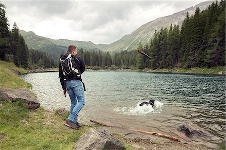 Man with dog hiking by lake, Tirol, Steiermark, Austria, Europe Stock Photo - Premium Royalty-Free, Code: 649-09026051