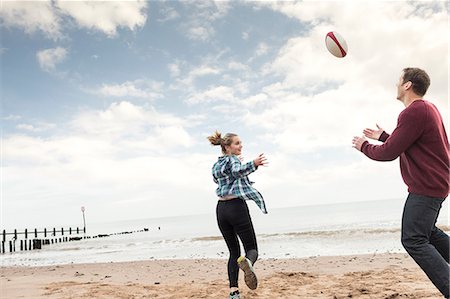 Father and daughter playing rugby on beach Stock Photo - Premium Royalty-Free, Code: 649-09026105