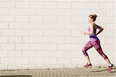 Young female runner running along sidewalk Stockbilder - Premium RF Lizenzfrei, Bildnummer: 649-09026110