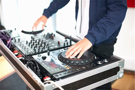 recording studio connecting - Young male college student spinning DJ turntables in recording studio Stock Photo - Premium Royalty-Free, Code: 649-09026208