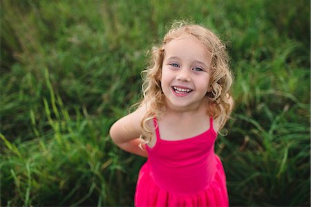 Portrait of blond haired girl in grass Fotografie stock - Premium Royalty-Free, Codice: 649-09035536