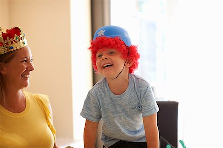 funny wig woman - Mother and son playing dress up, wearing funny hats, laughing Stock Photo - Premium Royalty-Free, Code: 649-09035567