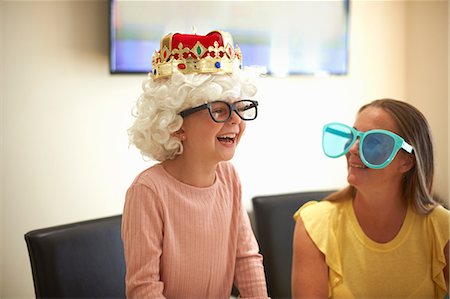 funny wig woman - Mother and daughter playing dress up, wearing funny hats and glasses, laughing Stock Photo - Premium Royalty-Free, Code: 649-09035568
