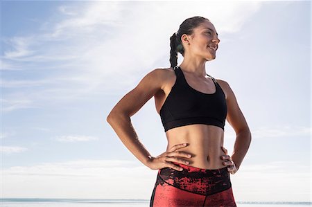 simsearch:649-07063009,k - Young female runner on beach with hands on hips against blue sky Stock Photo - Premium Royalty-Free, Code: 649-09035662